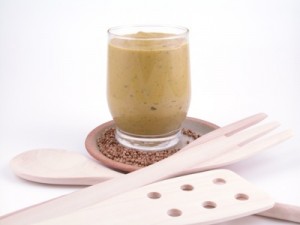glass of mustard with herbs on brown plate isolated